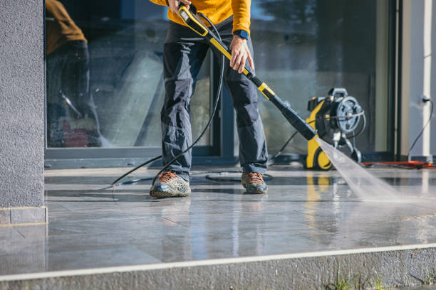 Man cleaning the terrace with high pressure cleaner Man cleaning the terrace with high pressure cleaner on beautiful sunny day. pressure washing stock pictures, royalty-free photos & images